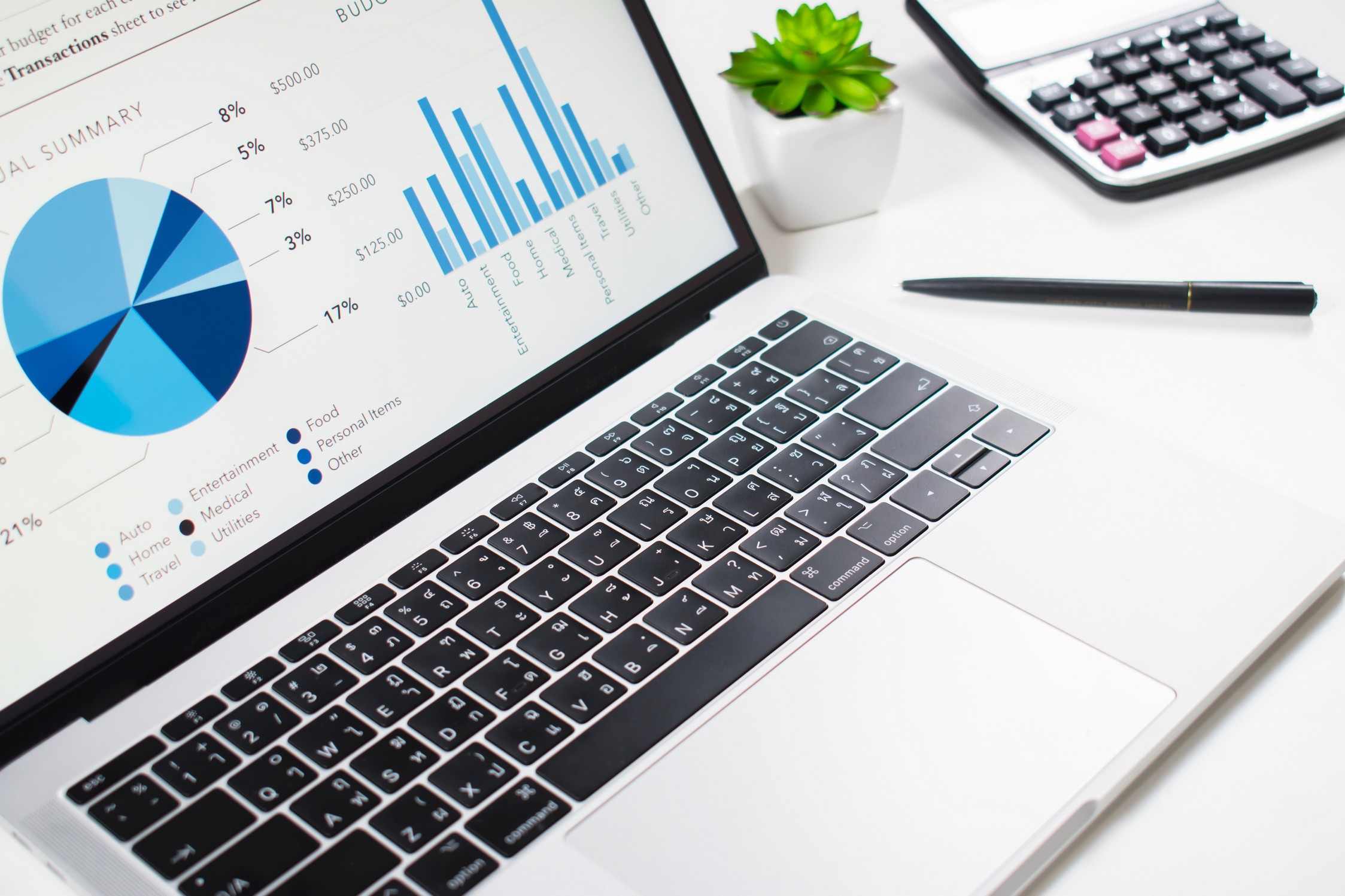 Business graph on a computer screen on a white table. Businessman used to explain at the meeting.
